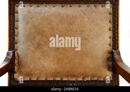 the back of an antique armchair upholstered in brown leather, closeup Stock Photo
