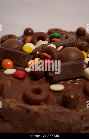 chocolate cake covered with chocolate cream and showered with candies Stock Photo