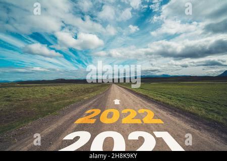 2022 New Year road trip travel and future vision concept . Nature landscape with highway road leading forward to happy new year celebration in the Stock Photo