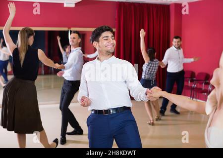 People practicing passionate samba in dance class Stock Photo