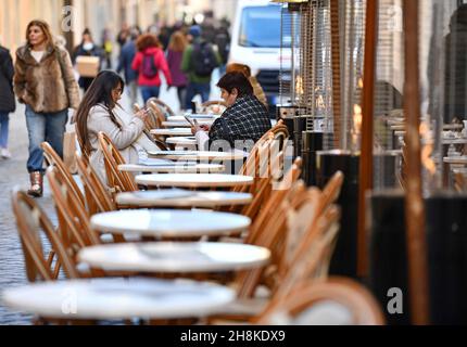 Rome, Italy. 30th Nov, 2021. People sit on the terrace of a restaurant in Rome, Italy, on Nov. 30, 2021. Italy on Tuesday reported 12,764 new COVID-19 cases, bringing the total number of confirmed COVID-19 cases to 5,028,547, according to the latest data from Italian Ministry of Health. Credit: Jin Mamengni/Xinhua/Alamy Live News Stock Photo