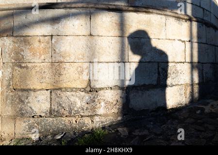 Salvador, Bahia, Brazil - July 18, 2021: Silhouette of the shadows of people on the stone wall in Pelourinho. Stock Photo