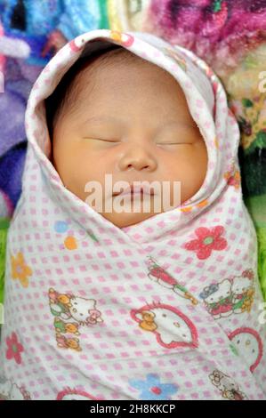 Ciamis, Indonesia - September 28, 2019 : Indonesian newborn babies are wrapped in cloth to keep them warm, Ciamis, West Java - Indonesia Stock Photo