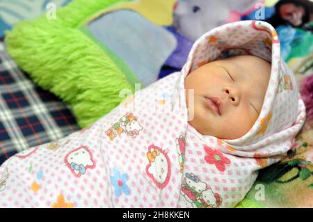 Ciamis, Indonesia - September 28, 2019 : Indonesian newborn babies are wrapped in cloth to keep them warm, Ciamis, West Java - Indonesia Stock Photo