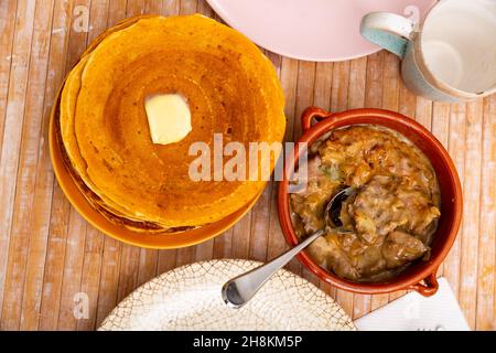 Pancakes with butter and mochanka of meat and mushrooms Stock Photo