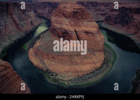 View of Horseshoe Bend, horseshoe-shaped incised meander of the Colorado River,  storm clouds in the sky, Page, Arizona, United States