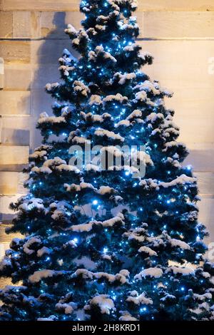 Christmas tree and lights outside brackley town hall in the evening snow. Brackley, Northamptonshire, England Stock Photo