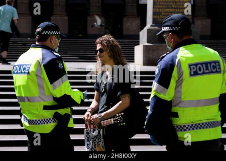 A freedom protester speaks to police at the State Library during the Freedom protest. Freedom protests are being held in Melbourne every Saturday and Sunday in response to the governments COVID-19 restrictions and continuing removal of liberties despite new cases being on the decline. Victoria recorded a further 21 new cases overnight along with 7 deaths. Stock Photo