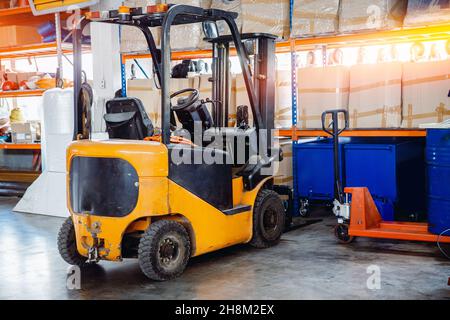 Industrial yellow forklift in warehouse Logistics store Stock Photo