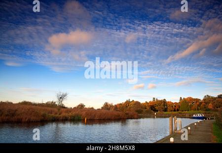 A view of the River Ant in autumn on the Norfolk Broads with mooring points downstream of How Hill, Ludham, Norfolk, England, United Kingdom. Stock Photo