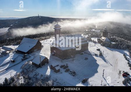 Oberwiesenthal, Germany. 23rd Nov, 2021. A thin layer of snow lies on the summit of the Fichtelberg. (Aerial view with drone) Credit: Jan Woitas/dpa-Zentralbild/dpa/Alamy Live News Stock Photo