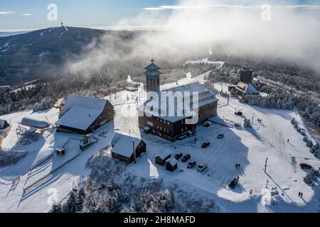 Oberwiesenthal, Germany. 23rd Nov, 2021. A thin layer of snow lies on the summit of the Fichtelberg. (Aerial view with drone) Credit: Jan Woitas/dpa-Zentralbild/dpa/Alamy Live News Stock Photo
