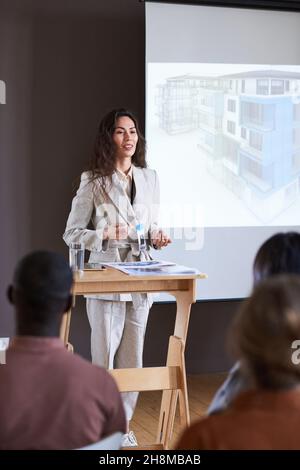 Young businesswoman performing at presentation with report for business people Stock Photo