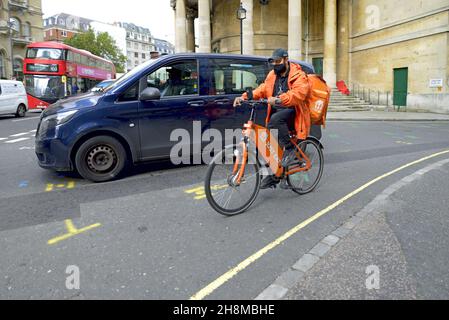 London, England, UK. Just Eat delivery cyclist in Langham Place Stock Photo