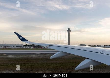 A view from the window over the wing of an Air France jet taxiing past the control tower at Miami International Airport in Miami, Florida. Stock Photo