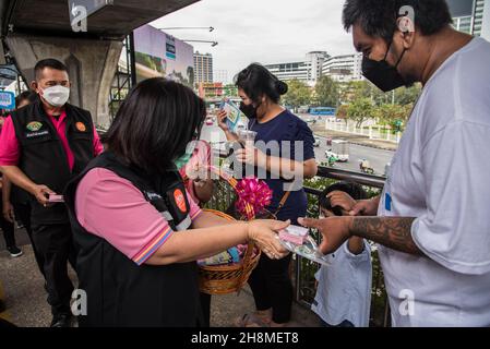 Bangkok, Thailand. 01st Dec, 2021. People receive condoms from Panurat  Noibunjong 