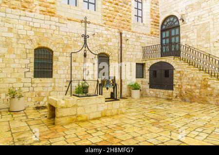 Jerusalem, Israel - November 20, 2021: View of a water well, in the yard of the Monastery of Saint Saviour (San Salvador), in the Old City of Jerusale Stock Photo