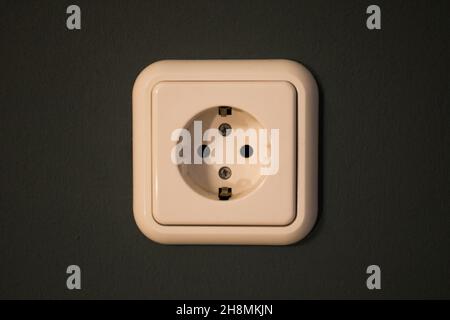 a white socket on a blue background in a closed room. interior design Stock Photo