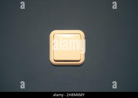 a white light switch on a blue background. turn off the light, turn on the light Stock Photo