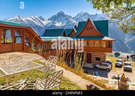 Wooden tourist lodge with view of majestic Kinnaur Kailash Himalaya mountain range at Kalpa, Himachal Pradesh, India Stock Photo