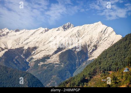 Scenic landscape at Kalpa hill station of Himachal Pradesh with forests on the mountain slopes and view of majestic Kinnaur Kailash Himalaya range Stock Photo