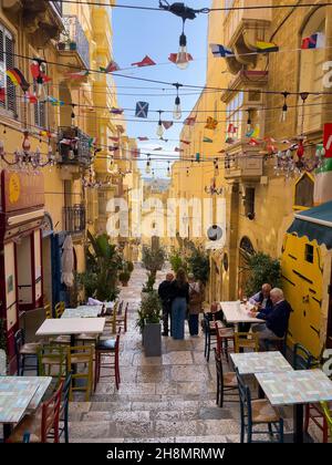 Steep narrow alley with cafes in Valletta Old Town, Valletta, Malta Stock Photo