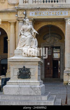 Marble statue of Queen Victoria in front of entrance to National Library of Malta building, Valletta, Malta Stock Photo