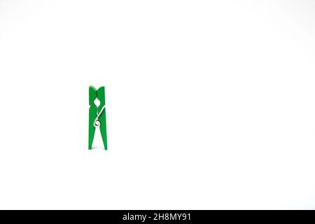 One green clothespins for laundry on a white background Stock Photo