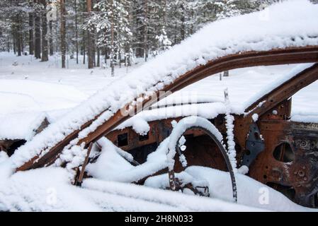 Snowy car wreck in the forest, Lapland, Finland Stock Photo