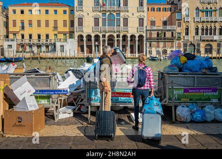 Tourists in Venice dispose of their old suitcases, Venice, Italy Stock Photo