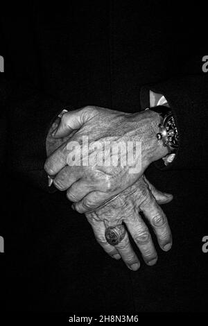 Men's hands with men's ring and wristwatch, studio shot in black and white Stock Photo