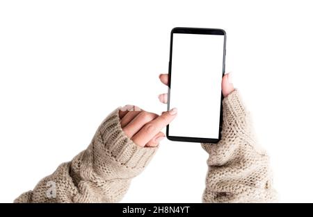 Top view of girl in sweater using smartphone Stock Photo