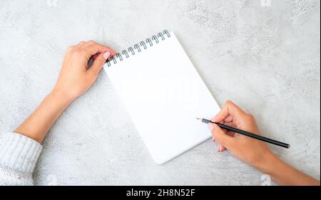 Girl holding a pencil in a hand Stock Photo