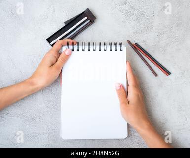 Girl's hands holding notebook Stock Photo