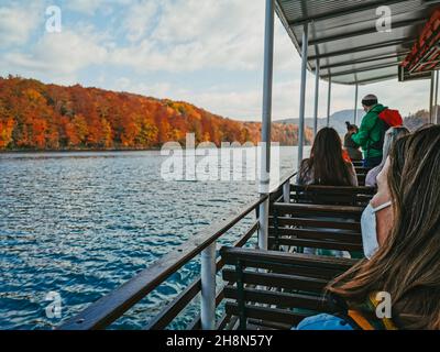 PLITVICE, CROATIA - Oct 29, 2021: A group of people on a tourist boat at famous Plitvice Lakes National Park in Croatia in autumn Stock Photo
