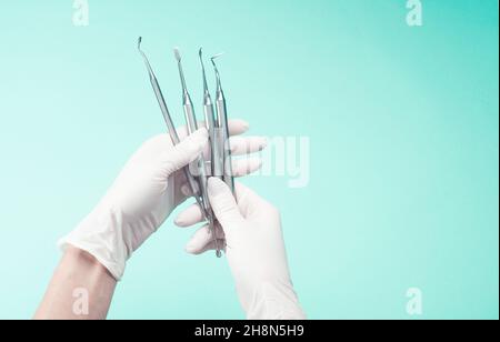 Hands in gloves holding medical tools Stock Photo