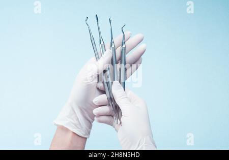 Hands in gloves holding medical tools Stock Photo