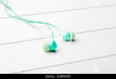 Digital earbuds on the table, macro with copyspace Stock Photo