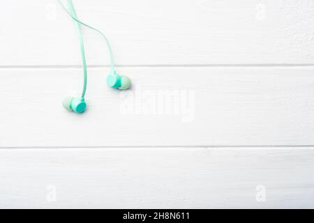 Digital earbuds on the table, macro with copyspace Stock Photo