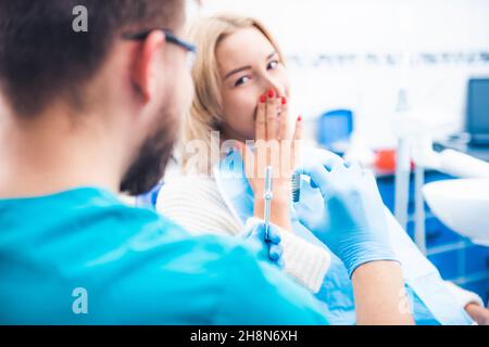 Dentist showing gray implant model Stock Photo