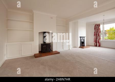 Cambridgeshire, England - November 4 2019: Vacant living room within British home with two fireplaces and no furniture. Stock Photo