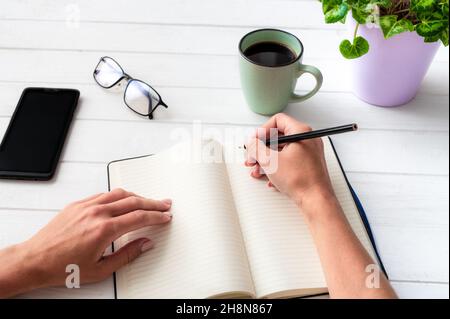 Top view of girl with notebook on white table Stock Photo