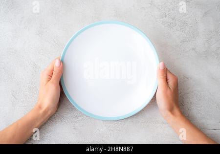 Girl holding plate Stock Photo