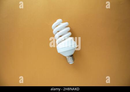 White light bulb, top view of light bulb isolated on colored background. Stock Photo