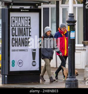 Southport, Lancashire.  UK Weather 01 Dec 2021. Change Climate Change sign. Christmas shops, shoppers shopping on a wet and windy day in the town centre. This morning's rain will clear southwards, butr fresh to moderate northerly winds will persist adding a considerable chill factor. Credit MediaWorldImages/AlamyLiveNews Stock Photo