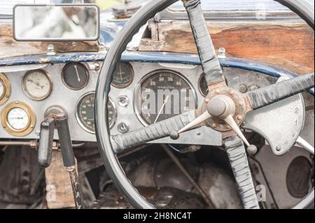 rusty and dusty vintage vehicle steering wheel and dashboard Stock Photo