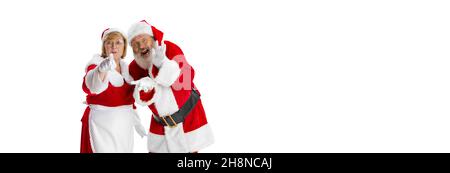 Happy smiling old man in Santa Claus costume and cute woman, missis Claus with congrats with Christmas isolated on white background. Stock Photo