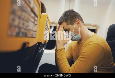 Airsickness. Man feels very bad on the plane. Stock Photo