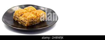 Walnut Baklava on white background. Turkish style walnut baklava presentation and service. Empty space for text. Copy space Stock Photo