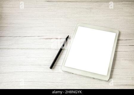 Top view white digital drawing tablet with pen on light wooden desk with copy space, office, home and computer concept Stock Photo